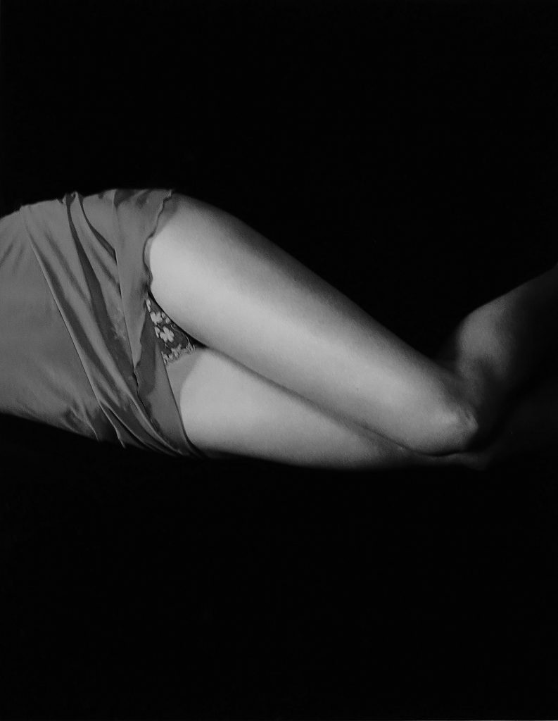 woman model lying on bed wearing panties and slip