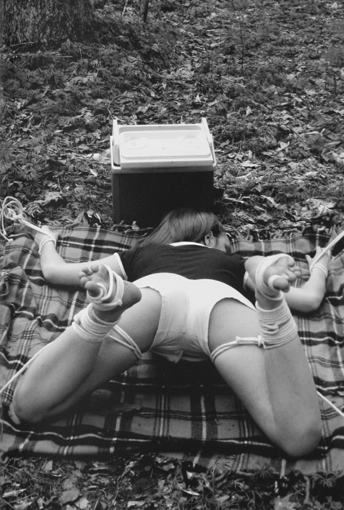 woman in bondage at outdoor picnic site