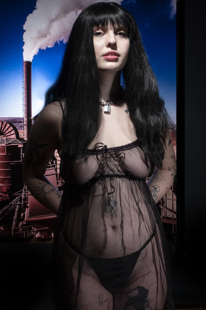 Portrait of young woman with black long hair wearing sheer nightgown 